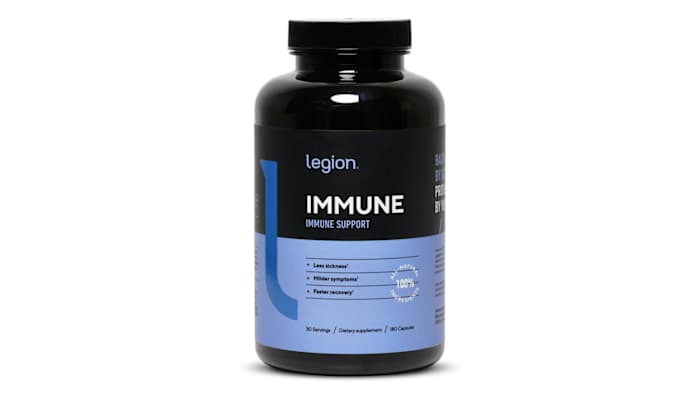 A black and lavender colored bottle of Legion Immune Support supplement with vitamin C against a white background.